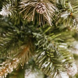 Snow Covered Christmas tree, with real natural cones, white snow, and silver crystals